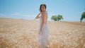 Romantic girl enjoying spikelets meadow. Tender woman posing summer rural nature Royalty Free Stock Photo