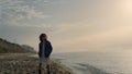 Romantic girl looking ocean view at sunrise. Dreamy woman walking on beach Royalty Free Stock Photo