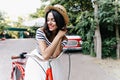 Romantic girl posing with shy smile while chilling outdoor. Portrait of magnificent woman in straw Royalty Free Stock Photo