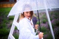 Romantic woman on walk hiding from rain under an umbrella in summer time. shallow depth of field photo Royalty Free Stock Photo