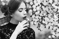 Romantic girl or young woman with white flower in mouth. Spring and summer. Nature beauty. Royalty Free Stock Photo