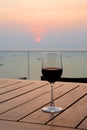 Romantic glass of red wine Standing on the beach at colorful sunset Royalty Free Stock Photo