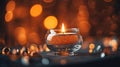 Romantic golden candle on table with blurred sparkling bokeh background.