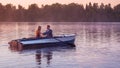 Romantic golden sunset river lake fog loving couple small rowing boat date beautiful Lovers ride during Happy woman man together r Royalty Free Stock Photo