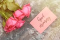 Romantic good morning concept. Red roses and lettering wishing good morning on a gray concrete background