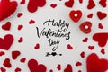 Romantic greeting card with hand written phrase happy valentines day in the center with different size red hearts on