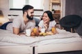 Happy couple having breakfast in bed Royalty Free Stock Photo