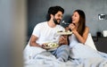 Romantic happy couple in love having breakfast in bed Royalty Free Stock Photo