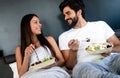 Romantic happy couple having breakfast in bed Royalty Free Stock Photo