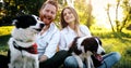 Romantic happy couple in love enjoying their time with pets in nature Royalty Free Stock Photo