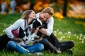 Romantic happy couple in love enjoying their time with pets in nature Royalty Free Stock Photo