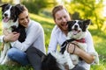 Romantic happy couple in love enjoying their time with pets in nature Royalty Free Stock Photo