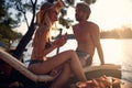 Romantic couple relaxing and eating watermelon together on vacation at sunset Royalty Free Stock Photo