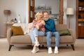 Romantic happy mature couple relaxing on couch at home Royalty Free Stock Photo
