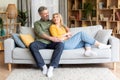 Romantic happy middle aged couple relaxing on couch at home Royalty Free Stock Photo