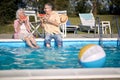 Romantic senior couple  enjoy on summer holiday near swimming pool and  eating watermelon Royalty Free Stock Photo