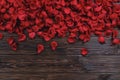 Beautiful bright red rose petals on wooden background. Happy valentines day oliday sales concept. Royalty Free Stock Photo