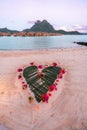 Romantic heart-shaped design made out of palm leaves on the beach. Bora Bora, French Polynesia