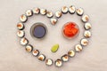 Romantic heart sushi dinner. Rolls with salmon, Philadelphia cheese and cucumber, ginger, wasabi and soy sauce . Concept for Royalty Free Stock Photo