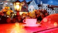 Romantic holiday city light Street cafe  bokeh blurring city light evening restaurant table cup of coffee on top view candle lamp Royalty Free Stock Photo