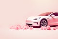 Luxury pink car on pink background with roses and copy space