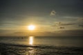 Ocean Sunset in Bali, Indonesia with small boats on water Royalty Free Stock Photo