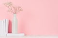Romantic home decor of white dry flowers in vase and pile white books on light pink background. Royalty Free Stock Photo