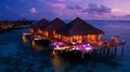 Romantic Hotels and Resorts on Maldives straw cabin evening blurred light blue sea water