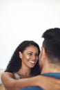 Romantic hugging and bonding couple feeling in love with a copyspace background. Portrait of a young female smiling at