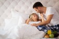 Romantic husband waking wife with breakfast Royalty Free Stock Photo