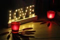 Romantic image with candles and the word love bright Royalty Free Stock Photo