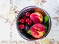 Fresh ripe summer berries and fruits, peaches, apricots, cherry and plum in a round plate on the table Royalty Free Stock Photo