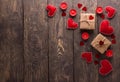 Romantic image for valentine`s day red hearts, candles and bright gifts on wooden background Royalty Free Stock Photo