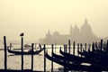 Romantic Italian city of Venice, a World Heritage Site: traditional Venetian wooden boats, gondolier and Roman Catholic