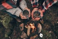 Romantic journey. Close up top view of young couple holding cups