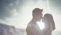 Romantic kiss backlit by the sun Royalty Free Stock Photo