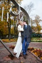 Romantic kiss bride and groom in autumn park Royalty Free Stock Photo