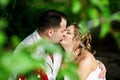 Romantic kiss bride and groom on wedding walk Royalty Free Stock Photo
