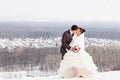 Romantic kiss happy bride and groom on winter wedding day Royalty Free Stock Photo