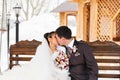 Romantic kiss happy bride and groom on winter wedding day Royalty Free Stock Photo