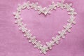 Romantic lacy heart on pink background
