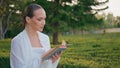 Romantic lady reading novel on go at beautiful park closeup. Woman turning pages Royalty Free Stock Photo