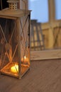 Romantic lantern reflection. Decorative mirror frame. Relaxing candlelight flame. Peaceful home interior