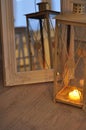 Romantic lantern reflection. Decorative mirror frame. Relaxing candlelight flame. Peaceful home interior