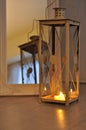 Romantic lantern reflection. Decorative mirror frame. Relaxing candlelight flame. Peaceful home interior