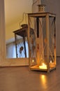 Romantic lantern reflection. Decorative mirror frame. Relaxing candlelight flame. Peaceful home interior