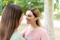 Happy young woman looking at her girlfriend