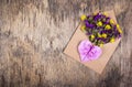 Romantic letter. Flowers in a paper envelope and a paper heart of origami. Royalty Free Stock Photo