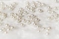 Romantic light pearl beads with white soft fur background Royalty Free Stock Photo