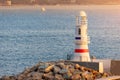 Lighthouse at the entrance to the bay and port of Kas on the Mediterranean coast of Turkey. Sunset and golden hour time Royalty Free Stock Photo